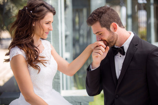 Gentlemen kissing woman's hand.