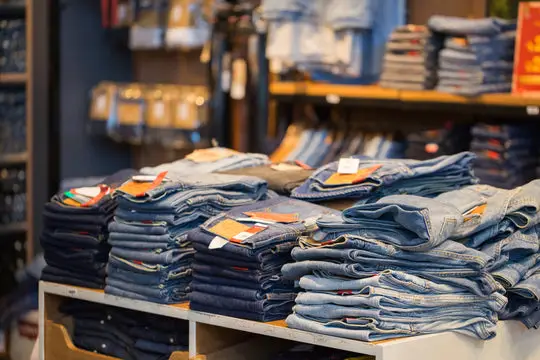 Stacks of mens jeans in store