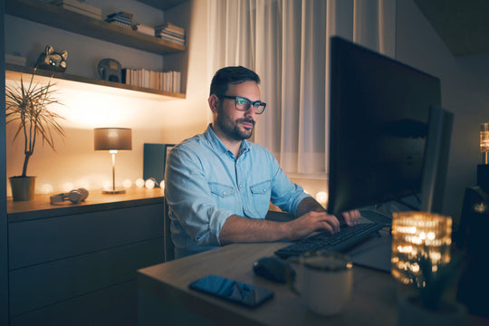 man at home office in blue shirt