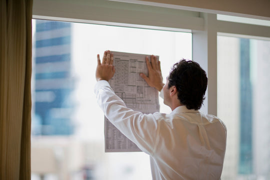 man at window wearing dress shirt with darts