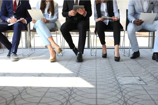 people dressed up awaiting a job interview
